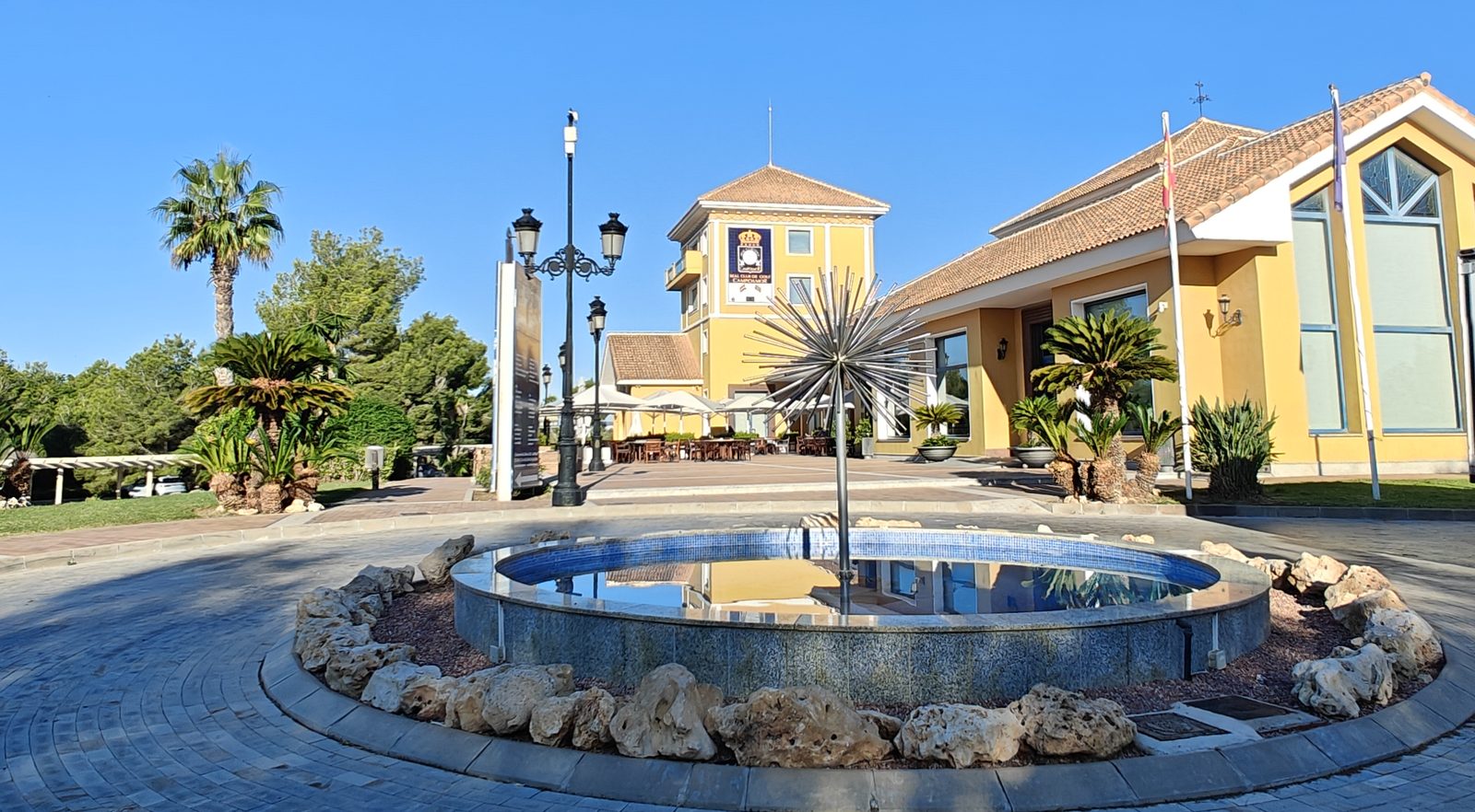Fountain in front of the yellow clubhouse at Real Club de Golf Campoamor