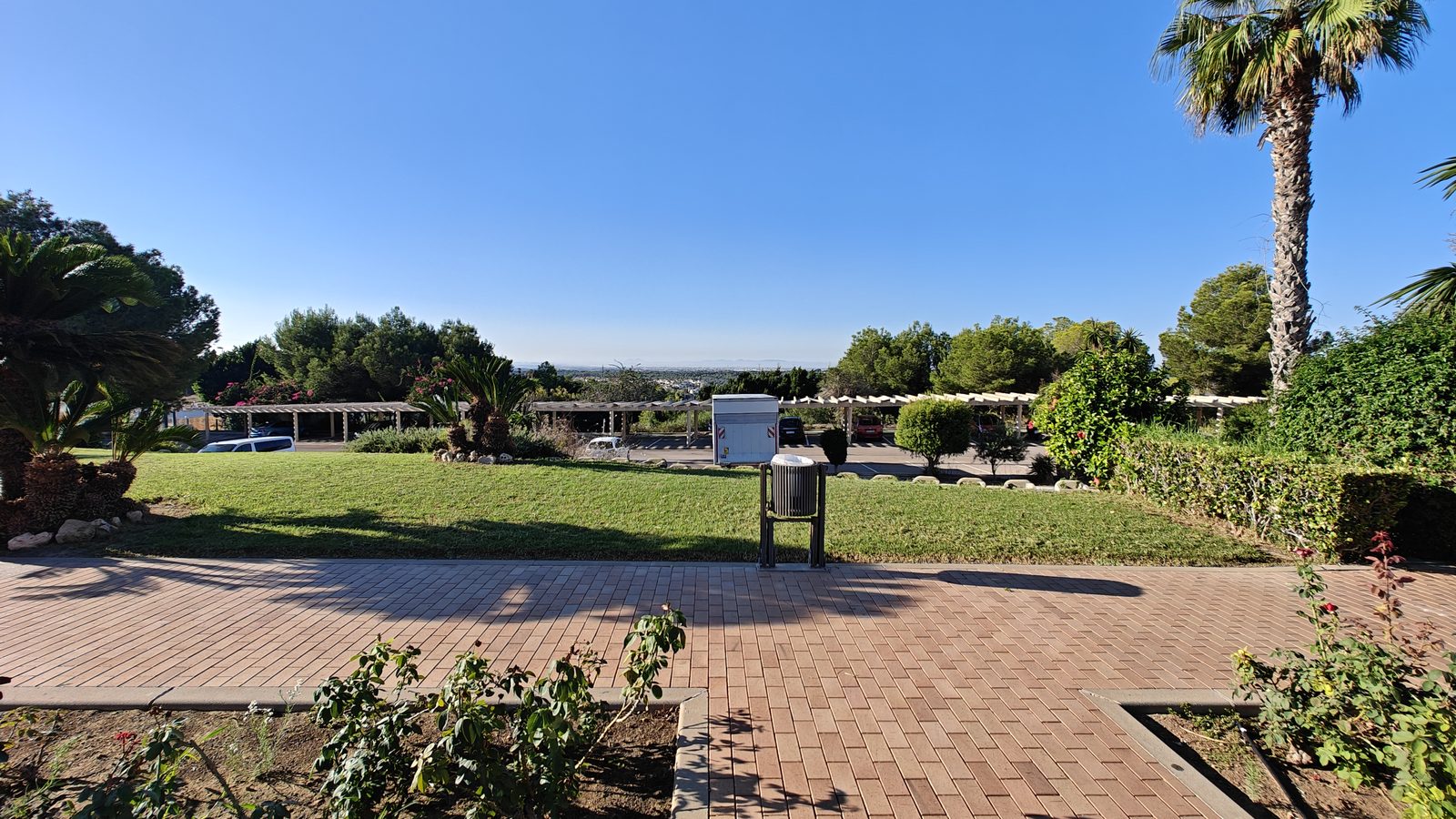 Paved terrace with lawns and planting at the Campoamor golf resort