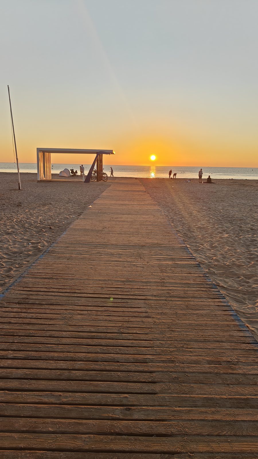 The wooden boardwalk leading to the sea at sunrise, La Zenia beach