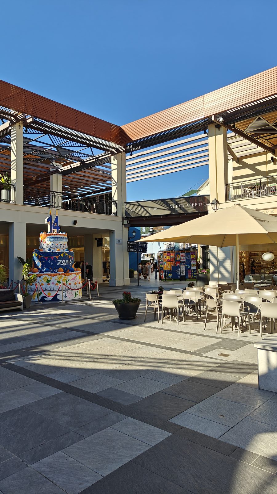 Shaded café terrace with parasols at Zenia Boulevard