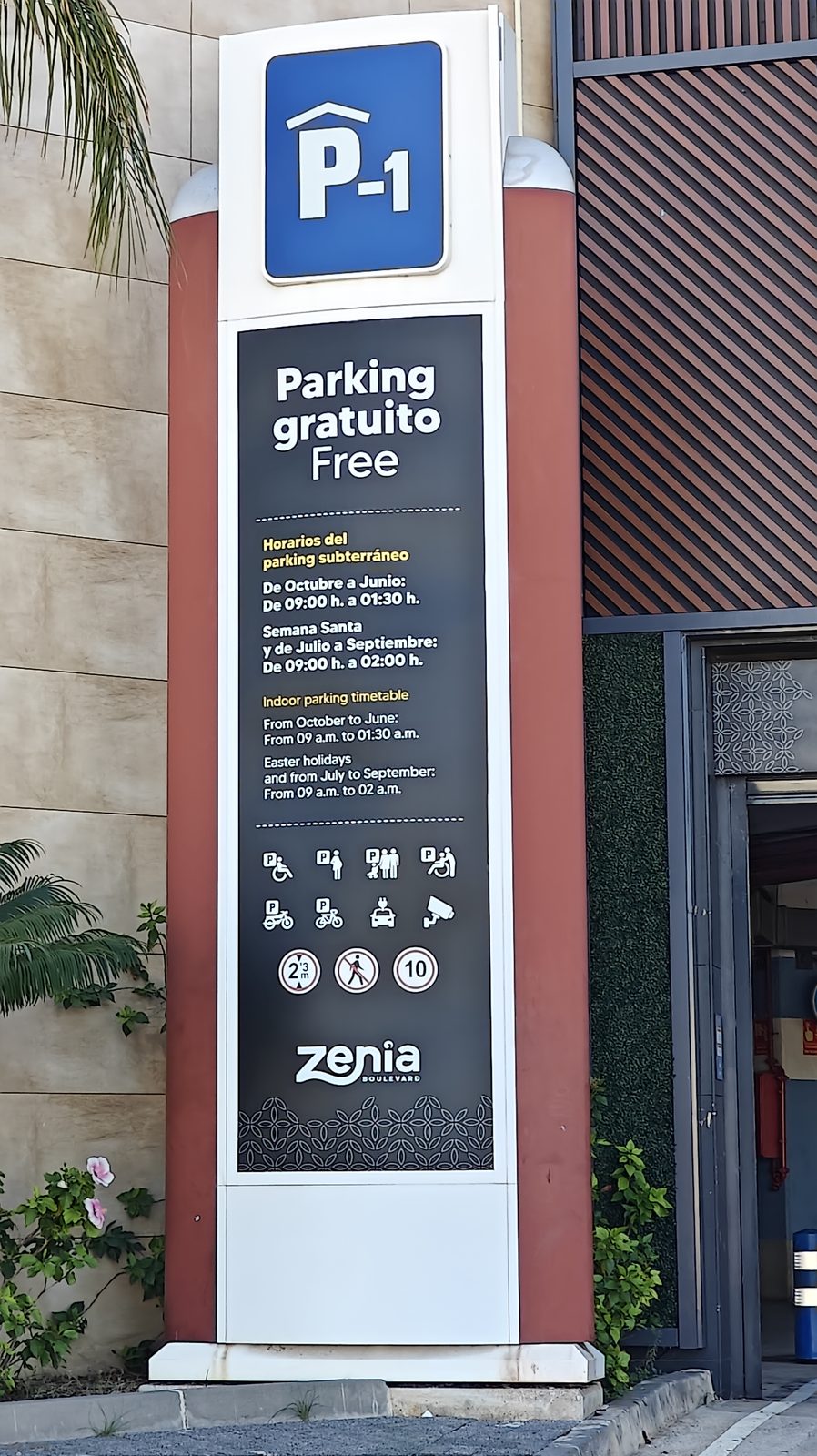 Sign for the free underground car park at Zenia Boulevard, with opening hours