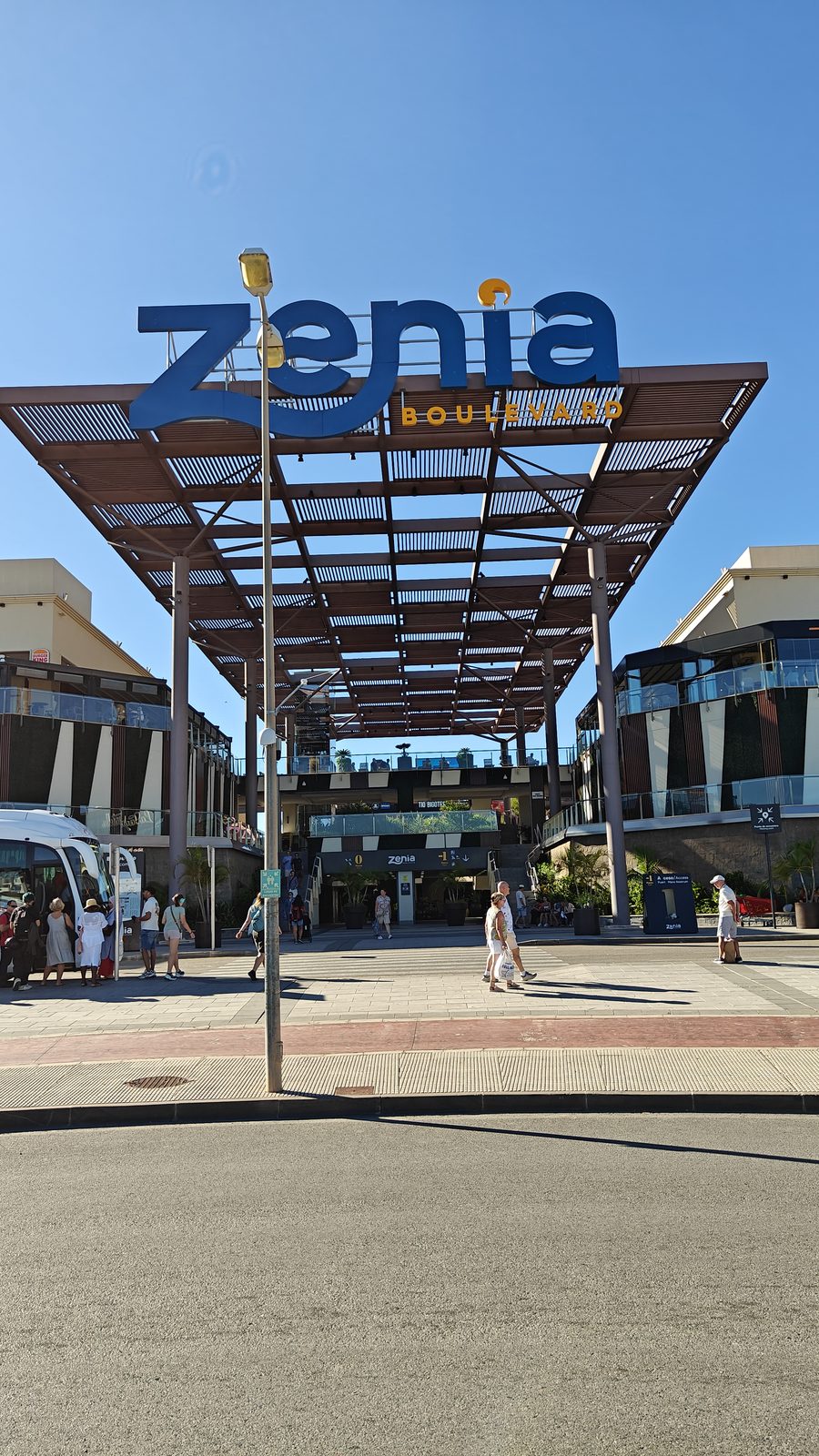 Zenia Boulevard's timber entrance canopy against a clear blue sky