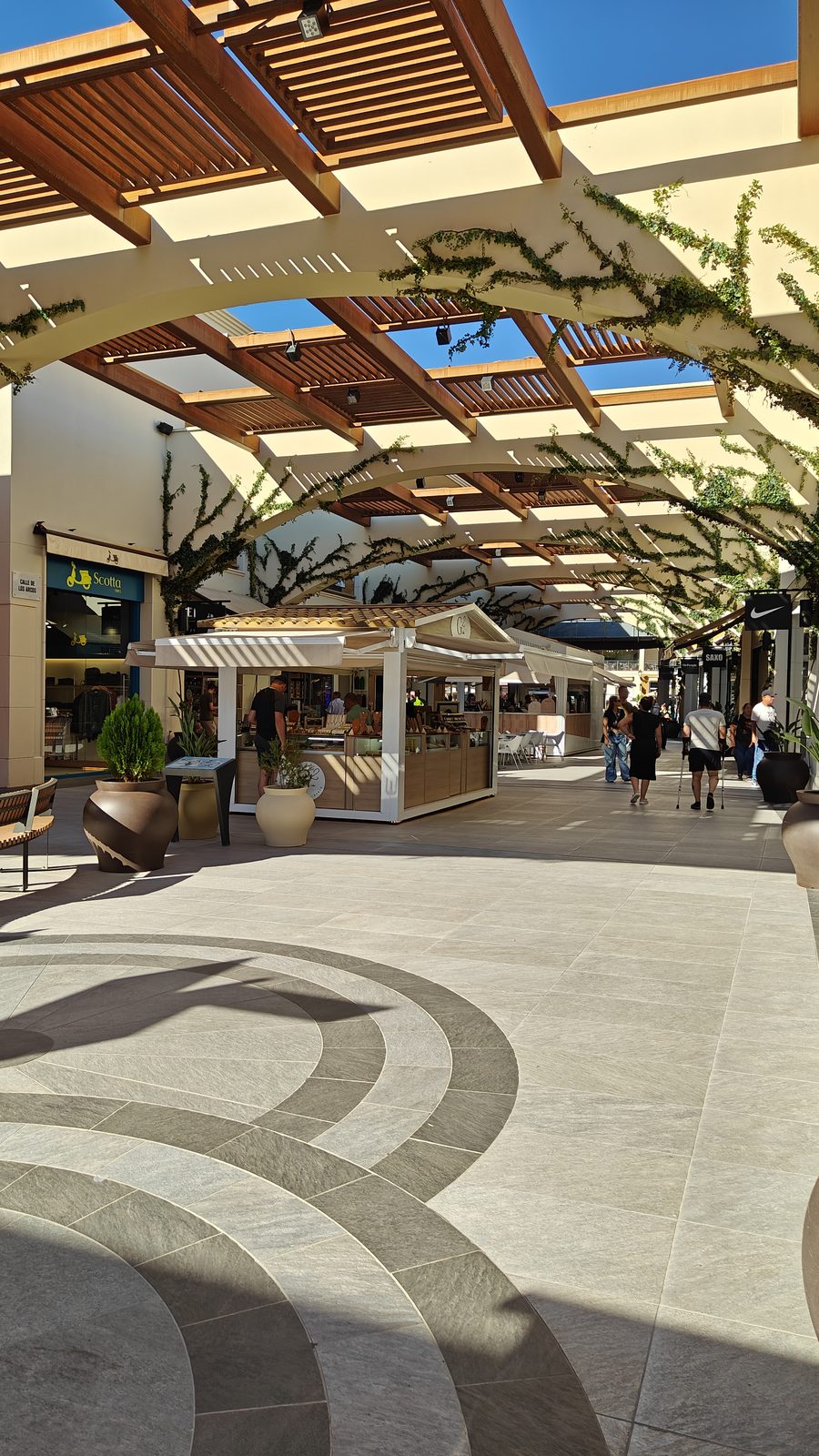 Pergola-covered walkway with a kiosk at Zenia Boulevard